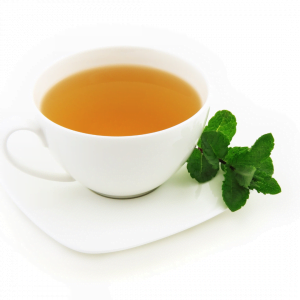 a white cup and saucer with an orange coloured tea and mint leaves on the side
