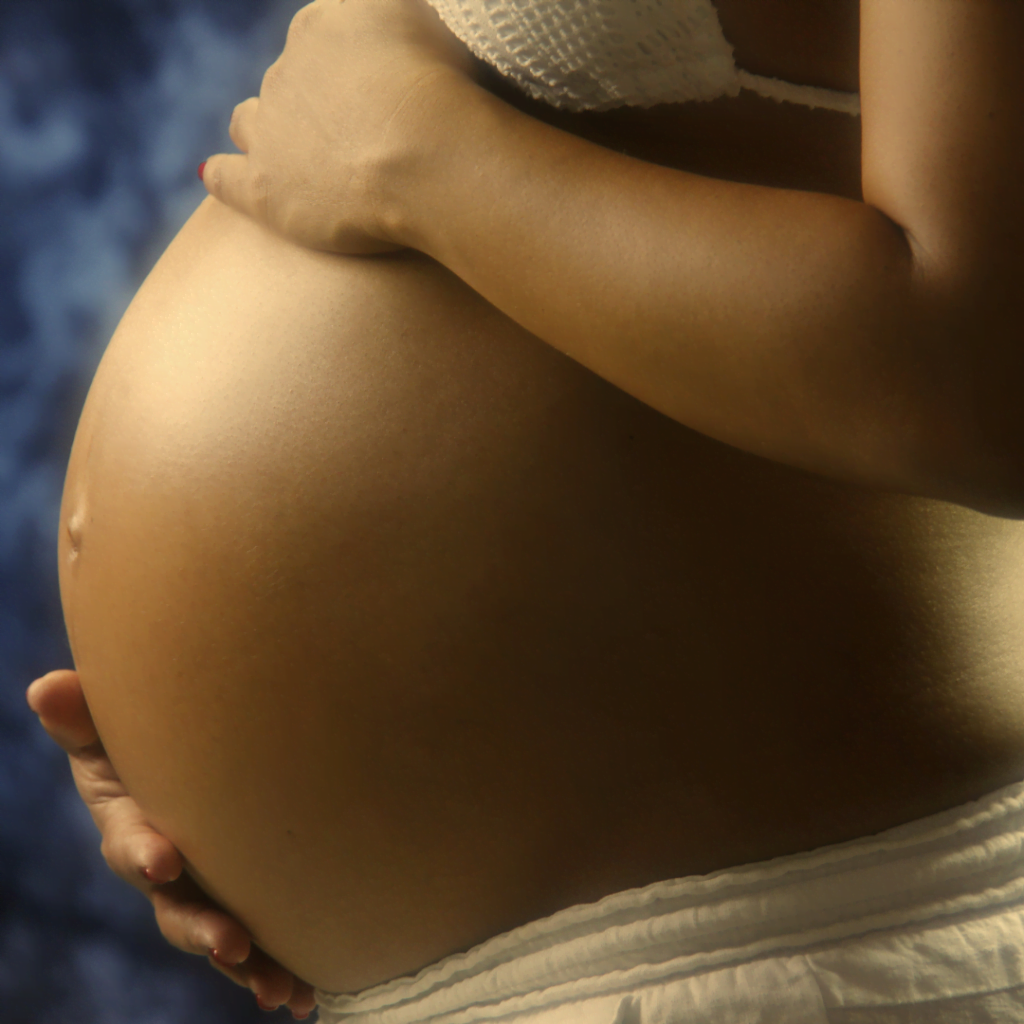 pregnant belly with an arm at the top and bottom