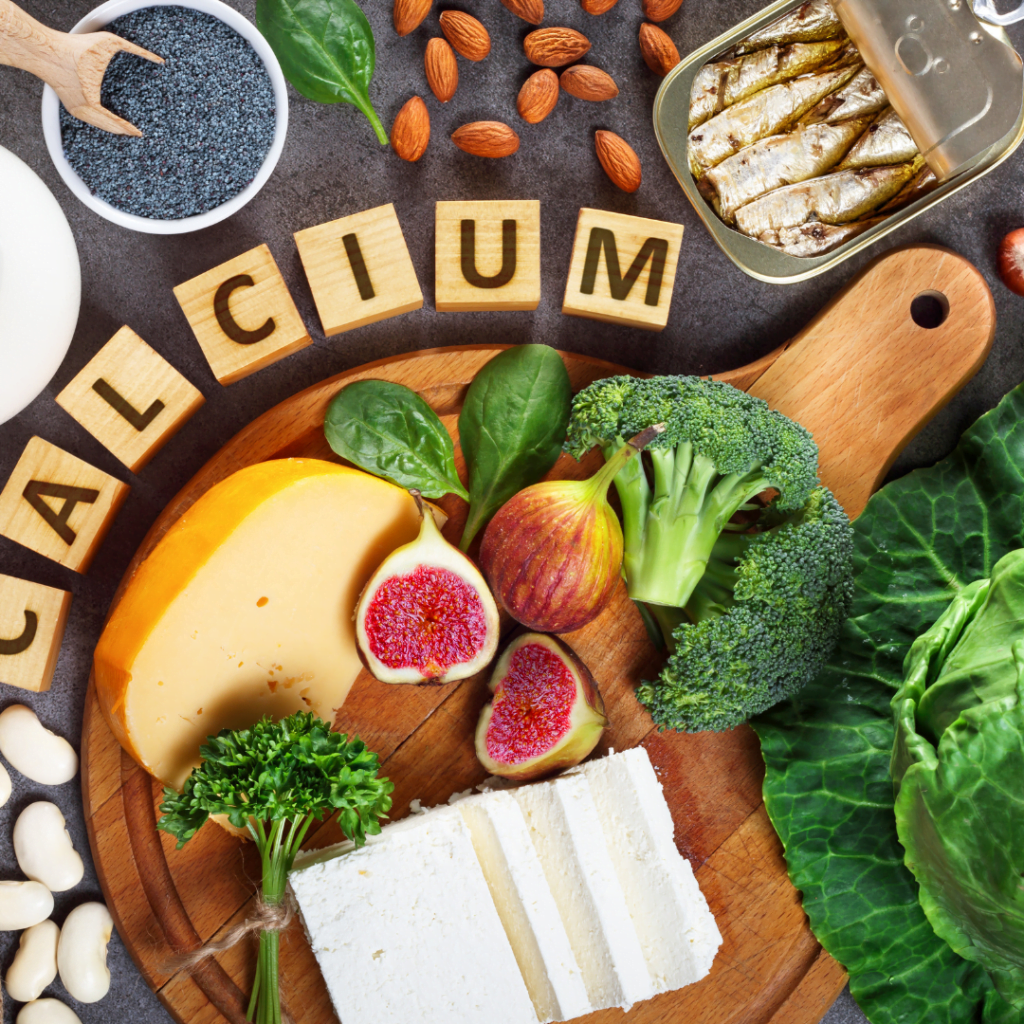 Calcium in scrabble tiles surrounded by seeds, greens, tofu, and cheese